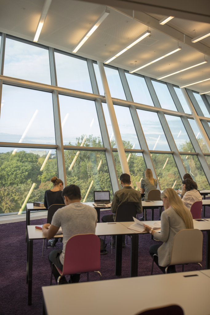 People sitting and studying in the WU library center.